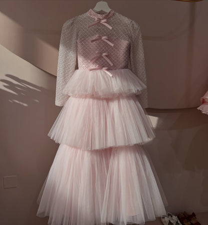 Delicate and elegant baby dress crafted in soft blush pink tones
